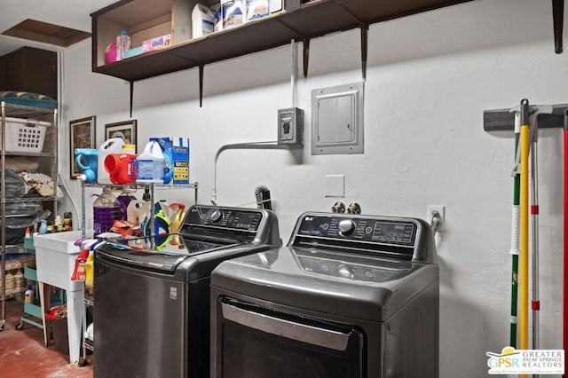 laundry room featuring electric panel and separate washer and dryer