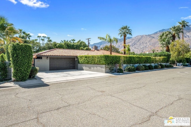 view of front of property with a mountain view and a garage