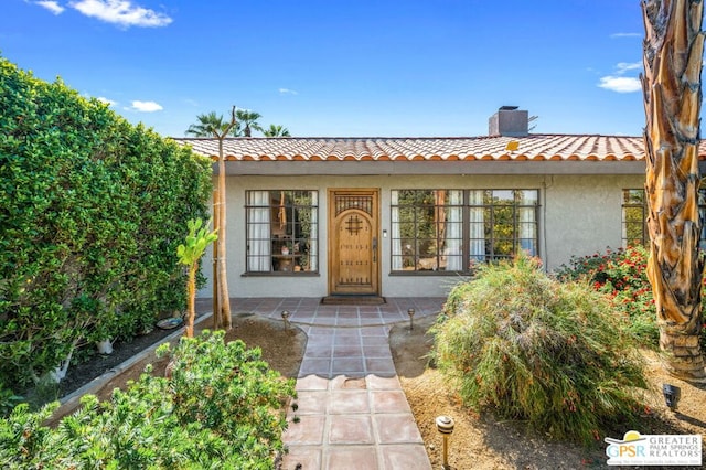 doorway to property with a patio area