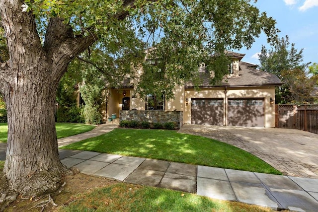 view of front of house featuring a garage and a front lawn