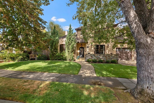 view of front of home featuring a garage and a front lawn