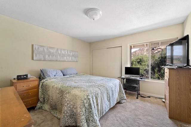 bedroom featuring light carpet and a closet