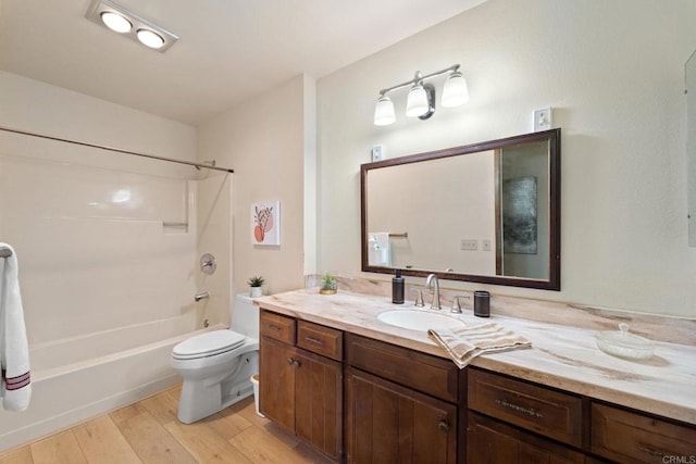 full bathroom featuring wood-type flooring, toilet, vanity, and bathing tub / shower combination