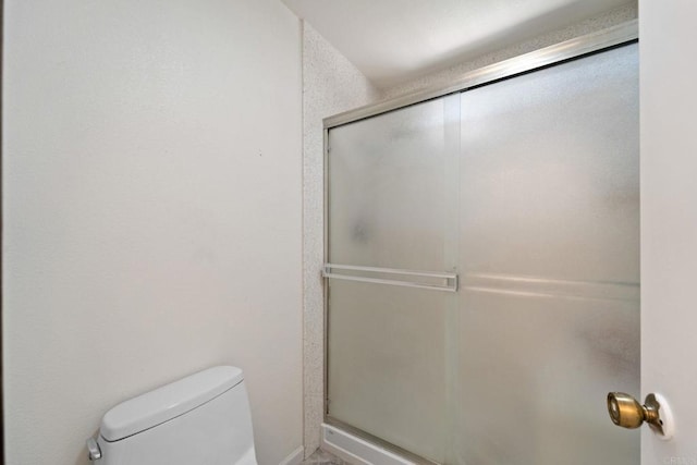 bathroom with toilet and walk in shower