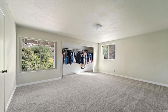 unfurnished bedroom with a closet and light carpet