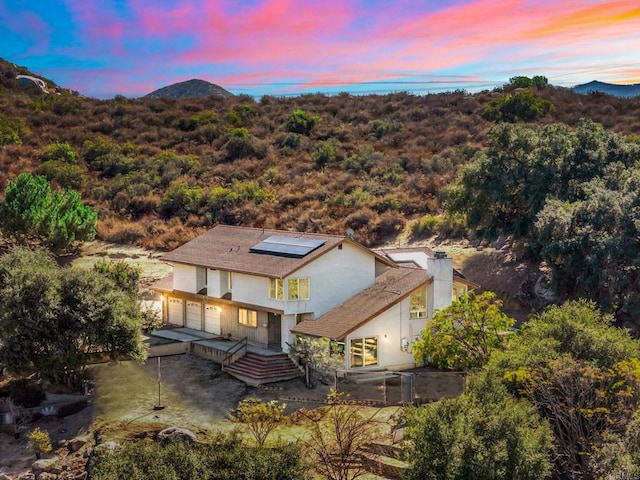 aerial view at dusk featuring a mountain view