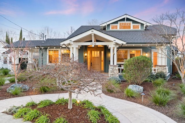 craftsman inspired home featuring covered porch