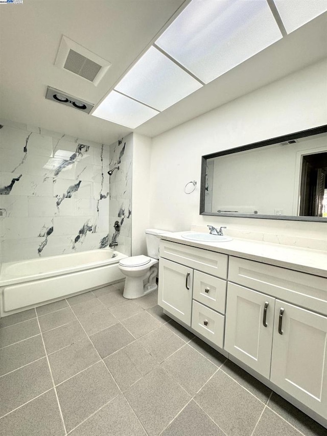 full bathroom featuring vanity, toilet, tile patterned flooring, and tiled shower / bath combo