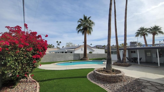 view of pool featuring a patio area and a lawn