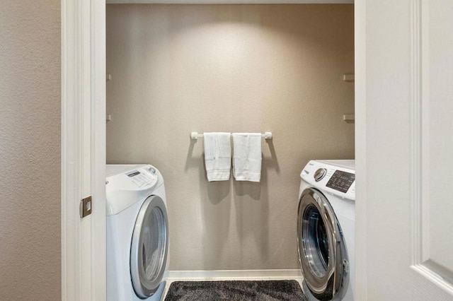 laundry room featuring separate washer and dryer