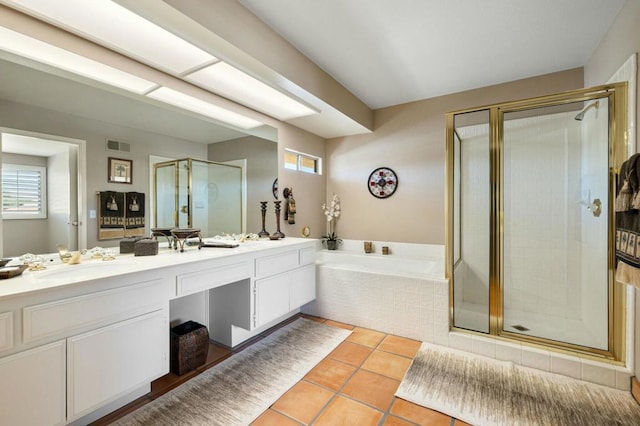 bathroom featuring vanity, independent shower and bath, and tile patterned flooring