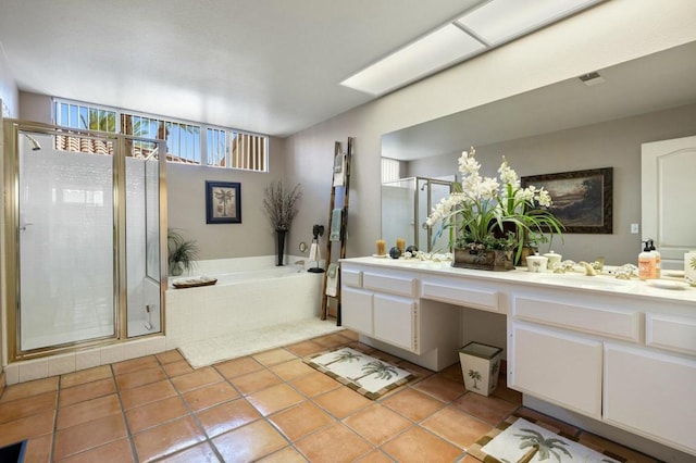 bathroom with tile patterned flooring, shower with separate bathtub, and vanity