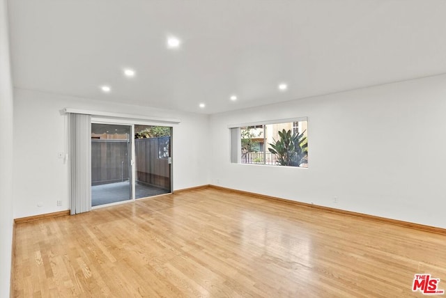 unfurnished room with hardwood / wood-style floors