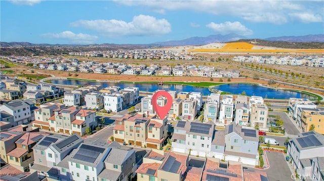 birds eye view of property with a water and mountain view