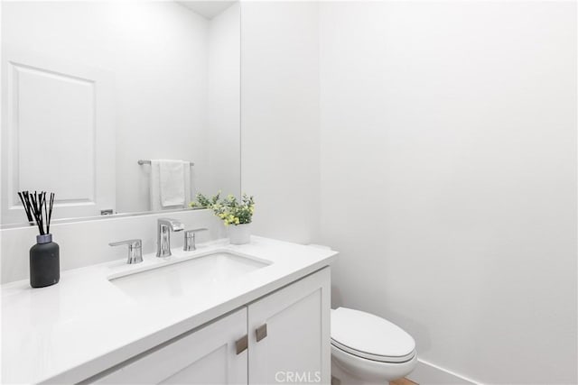 bathroom featuring toilet and vanity