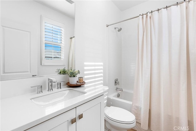 full bathroom featuring toilet, vanity, and shower / bath combination with curtain