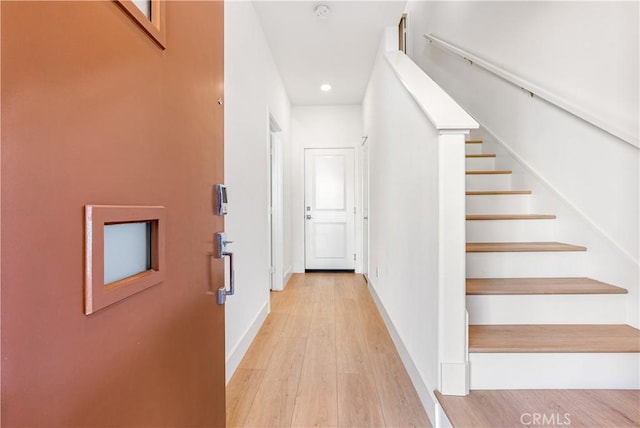 stairs featuring hardwood / wood-style floors