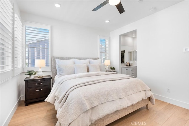 bedroom featuring ceiling fan, connected bathroom, and light hardwood / wood-style flooring