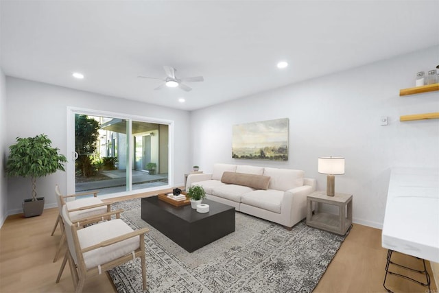 living room featuring ceiling fan and light hardwood / wood-style flooring