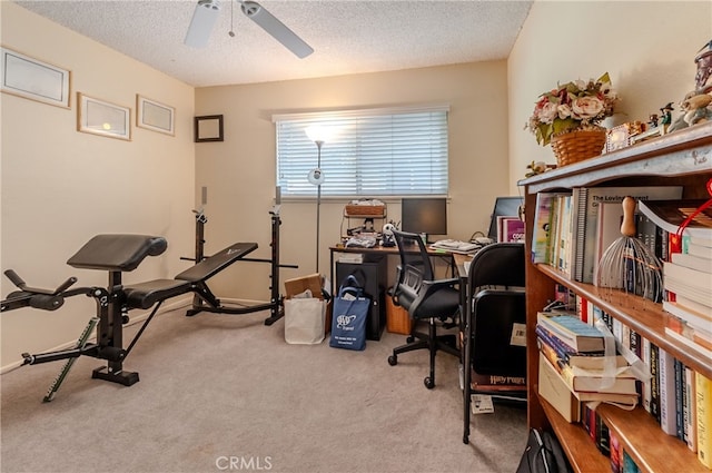 office area with ceiling fan, a textured ceiling, and light carpet