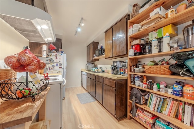 kitchen with light hardwood / wood-style flooring, sink, track lighting, white appliances, and dark brown cabinetry