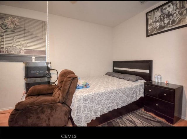 bedroom with hardwood / wood-style flooring