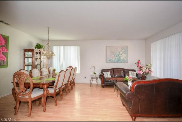 dining area featuring a chandelier and light wood-type flooring