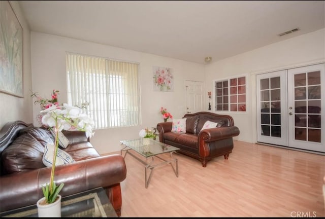 living room with french doors and hardwood / wood-style flooring