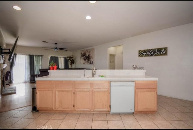 kitchen with tile counters, white dishwasher, light brown cabinetry, and sink