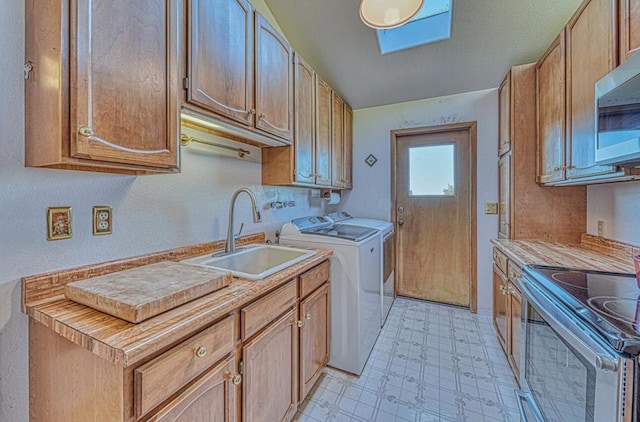 clothes washing area with sink and washing machine and dryer