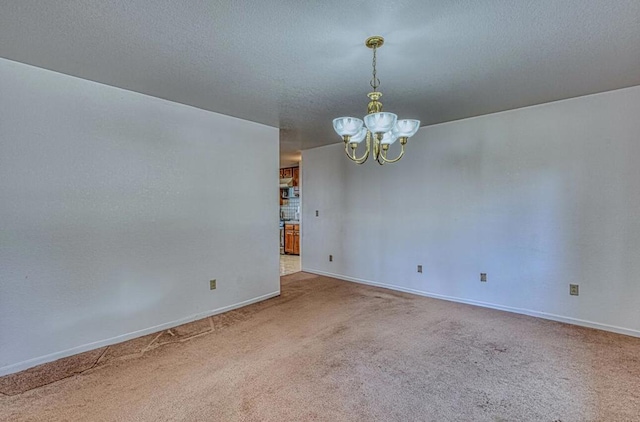 unfurnished room with an inviting chandelier and carpet