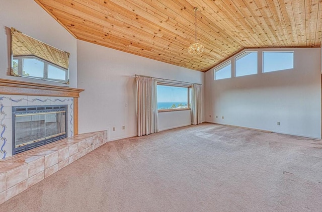 unfurnished living room featuring wooden ceiling, a tiled fireplace, high vaulted ceiling, and carpet