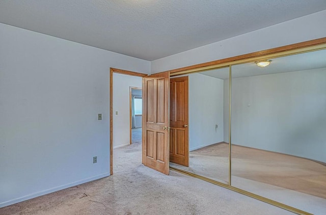 unfurnished bedroom with a closet and light carpet