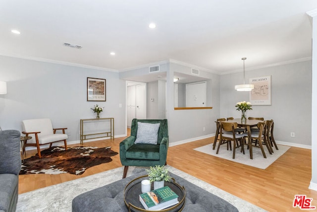 living room featuring crown molding and hardwood / wood-style flooring