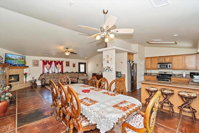 dining space with vaulted ceiling and ceiling fan