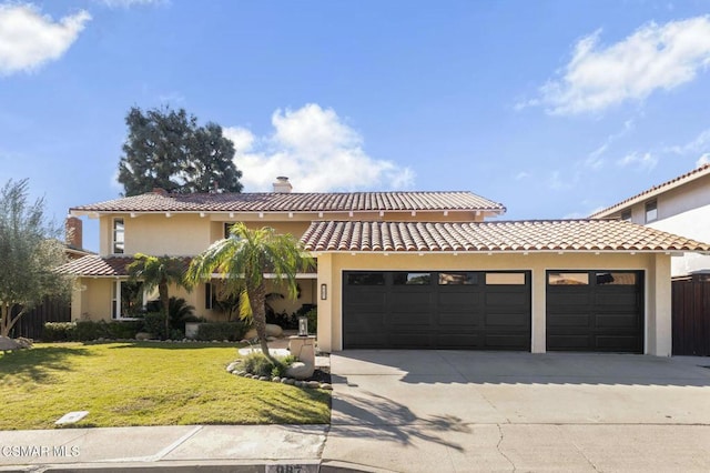 mediterranean / spanish house with a garage and a front lawn