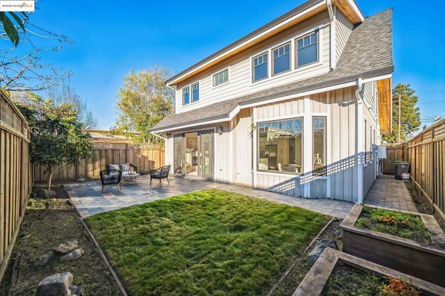 rear view of house with a patio area and a yard