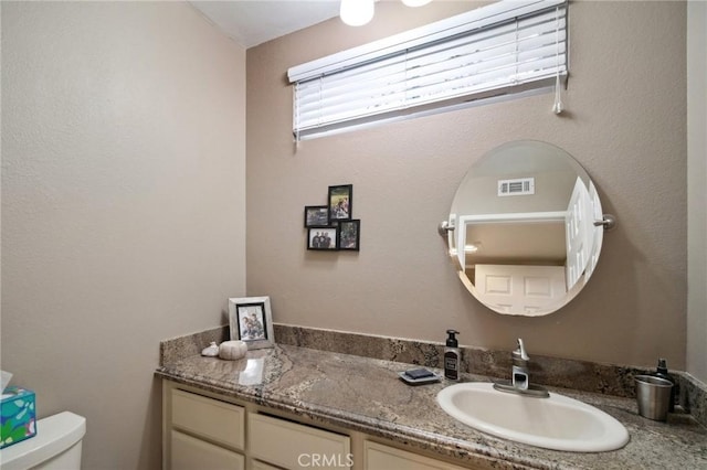 bathroom with toilet and vanity