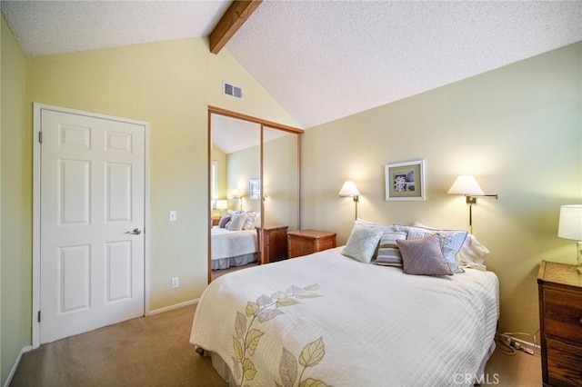 carpeted bedroom with a textured ceiling, lofted ceiling with beams, and a closet