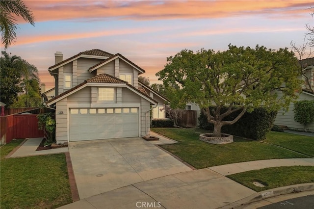 front facade featuring a yard and a garage