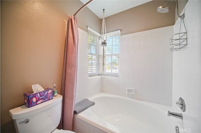 bathroom featuring toilet and shower / tub combo with curtain