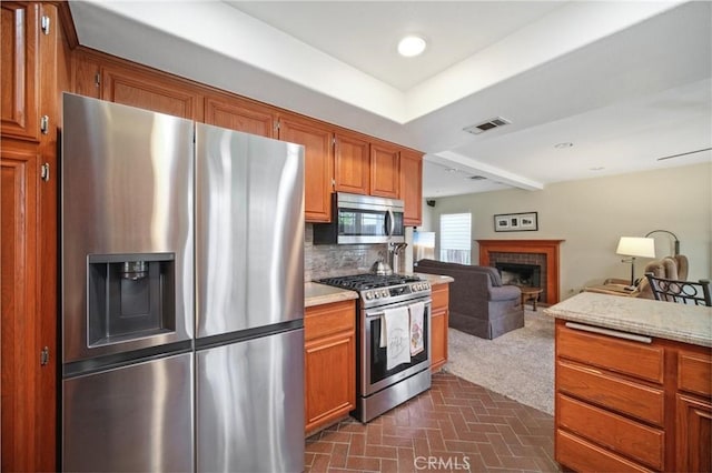 kitchen with stainless steel appliances and tasteful backsplash