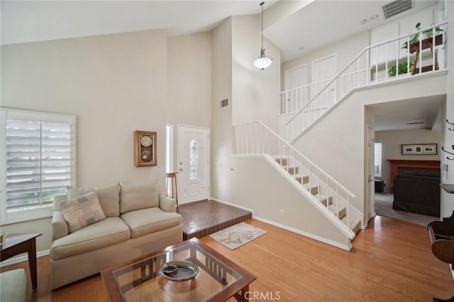 living room featuring hardwood / wood-style floors and high vaulted ceiling