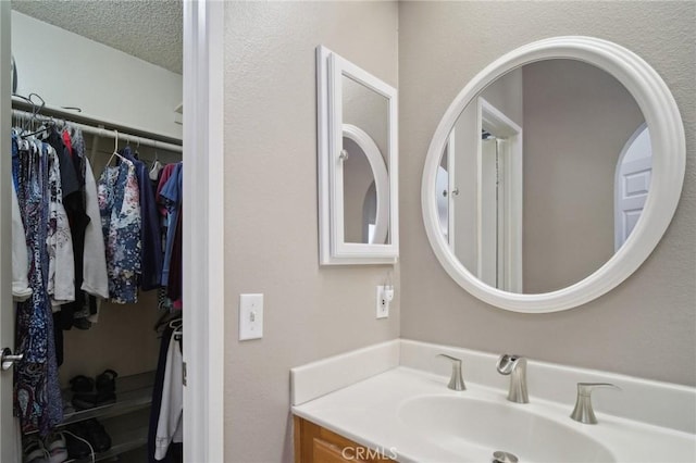 bathroom with vanity and a textured ceiling