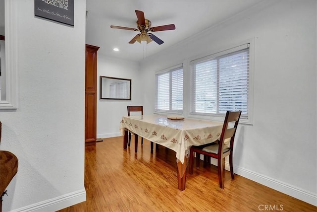 dining space featuring ceiling fan and light wood-type flooring