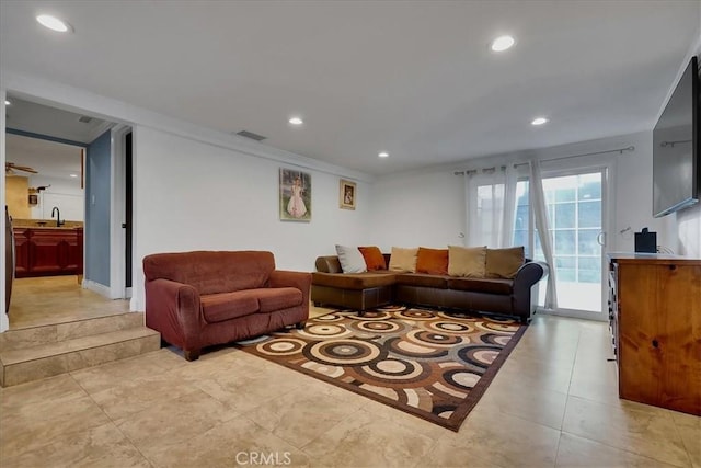 living room featuring sink and ornamental molding