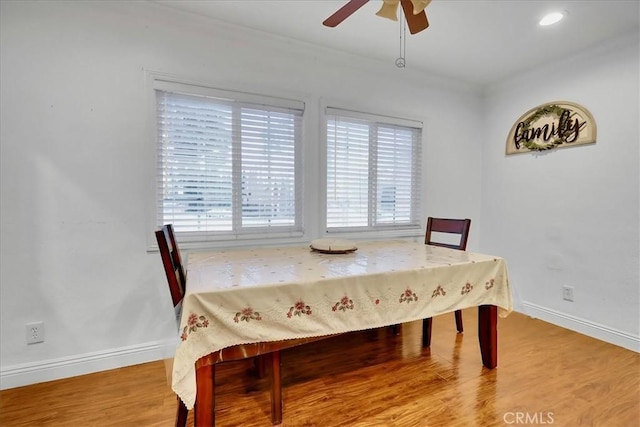 dining room with hardwood / wood-style floors and ceiling fan