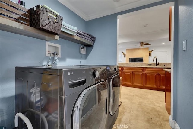 laundry room featuring sink, crown molding, washer and dryer, light tile patterned floors, and ceiling fan