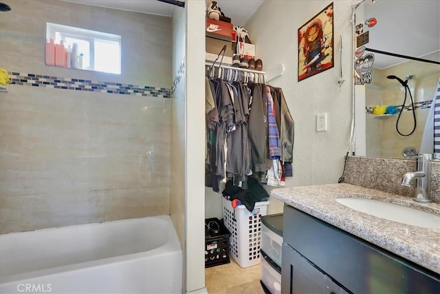 bathroom featuring vanity and tiled shower / bath combo