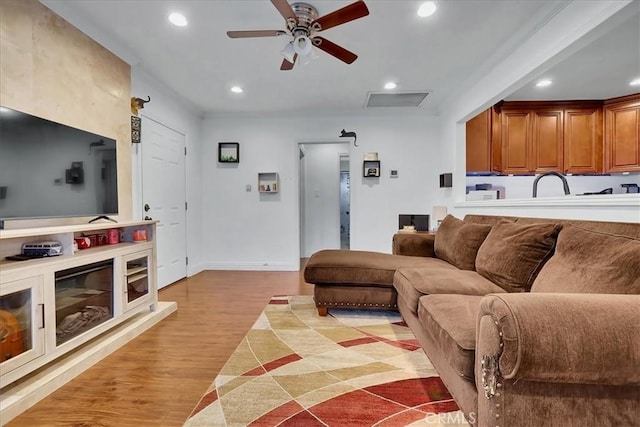 living room featuring ceiling fan and light hardwood / wood-style floors